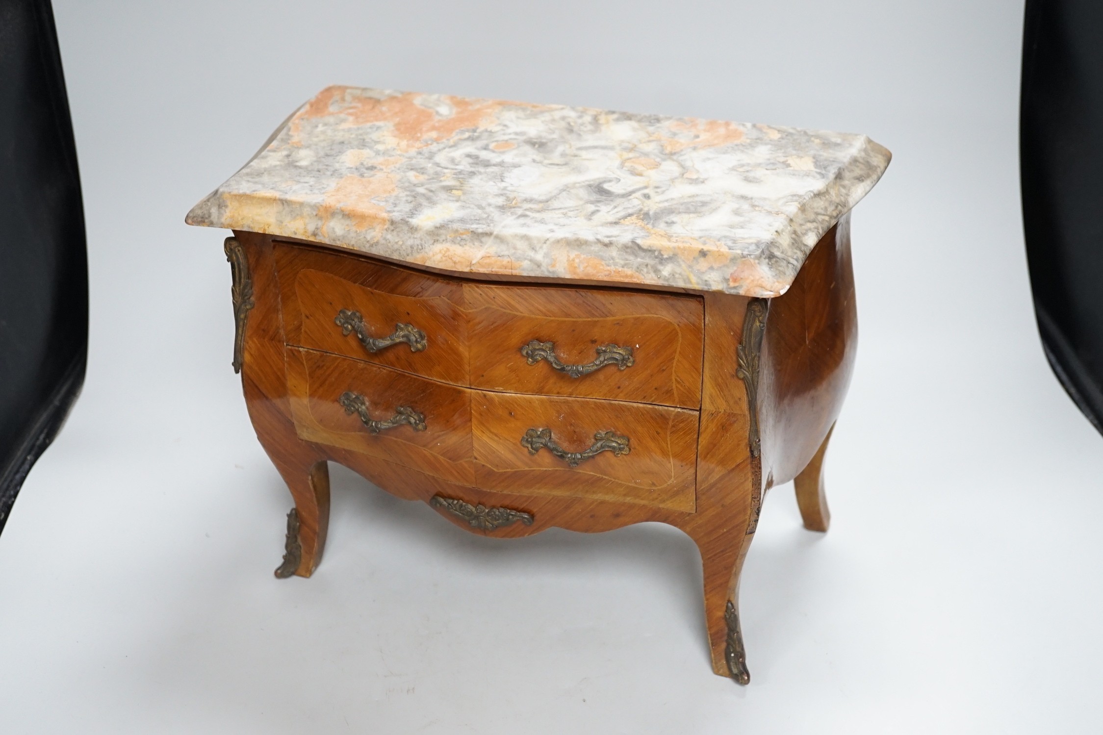 An Apprentice piece: Louis XV style miniature bowfronted French chest, with gilt mounts and pink and grey marble top. 27cm tall, 36cm wide, 17cm deep